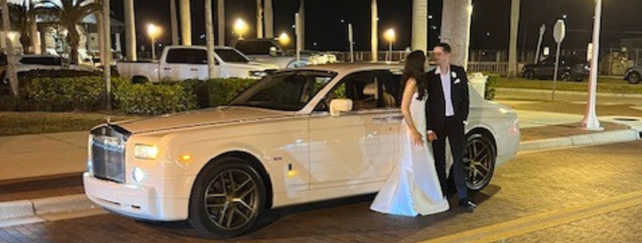 Photo of Bride and Groom in front of Rolls Royce