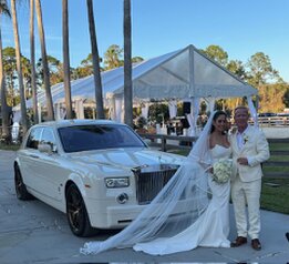 Photo of Bride and Groom in front of Rolls Royce