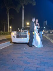 Photo of Bride and Groom in front of Limo